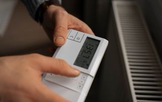 Mains tenant un thermostat